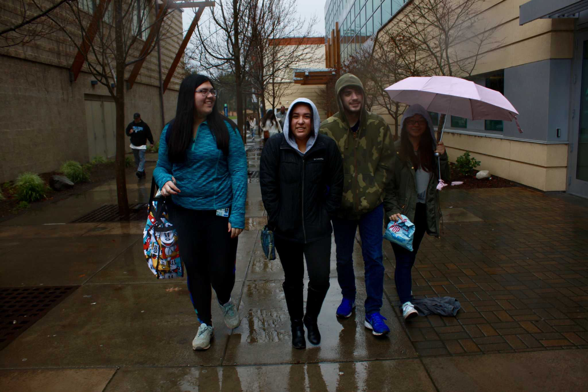 Students try to stay dry in the rainy weather on Sat. Feb. 16, 2019.