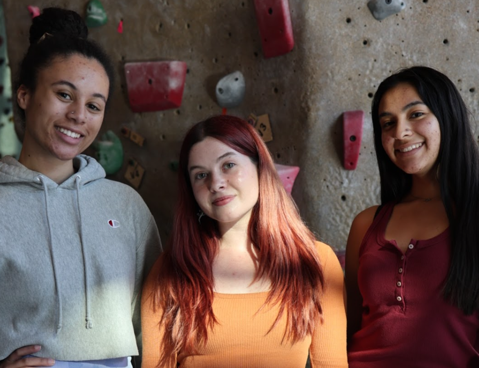 Students gather at the rock wall in the Rec Center (Left to Right - Mariah Gragg, Amanda Davis, Macayla Sedeno).